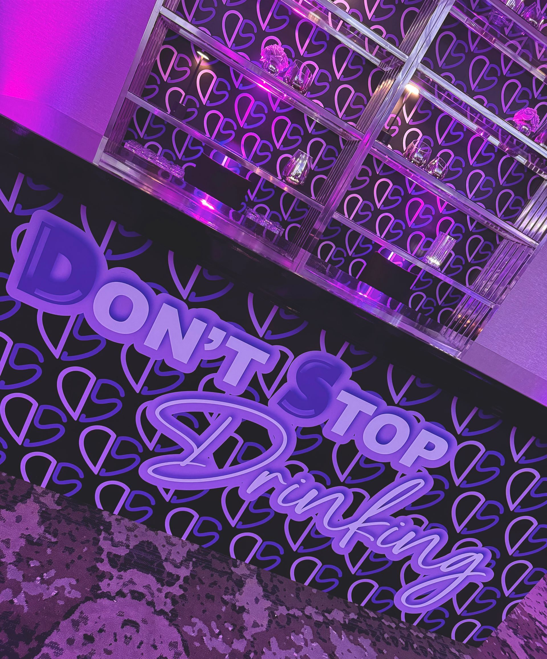 A purple sign that says do n't stop drinking