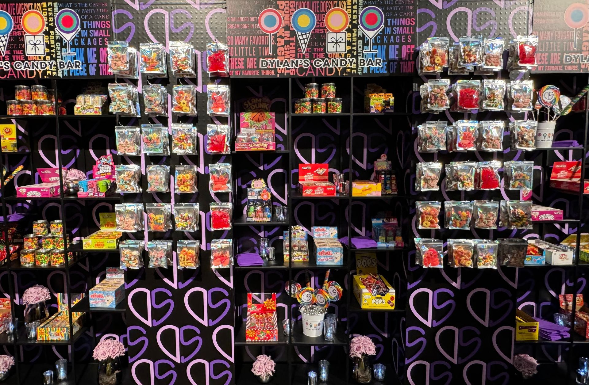 A store filled with lots of candy and hearts on the wall.