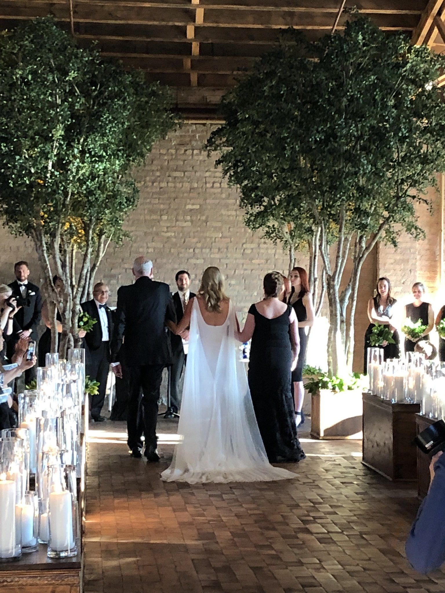 A bride and groom are walking down the aisle at a wedding ceremony.
