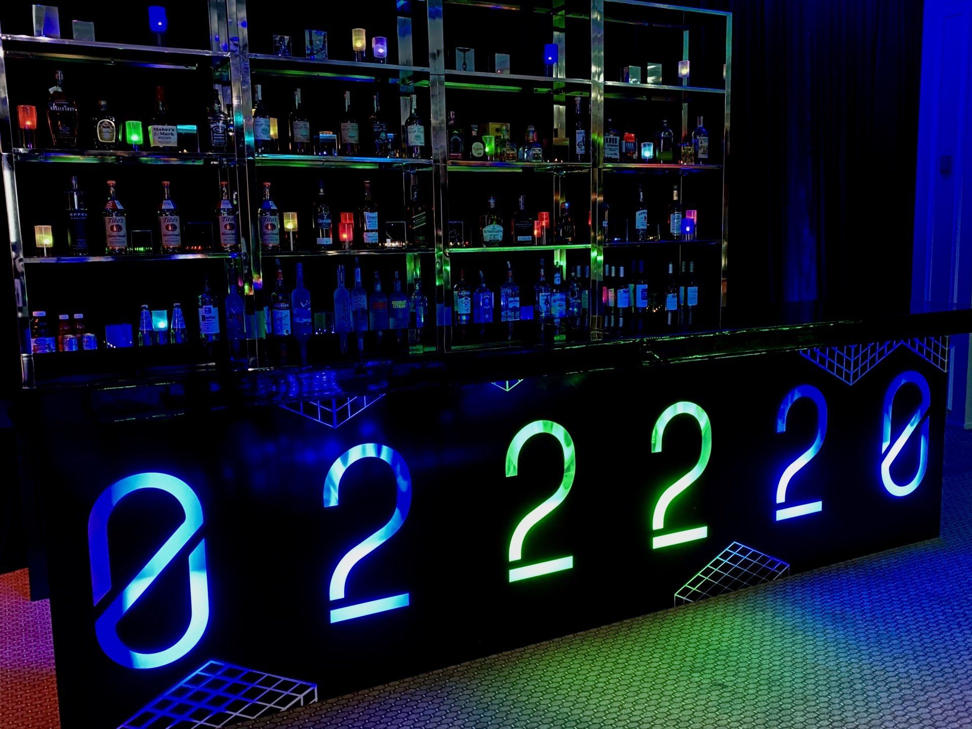 A bar with a neon sign that says ' 2222 ' on it