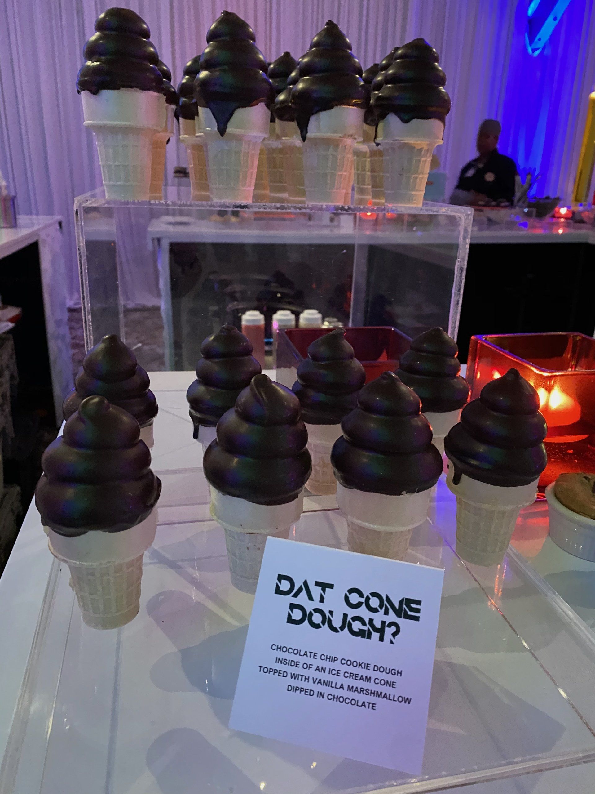 A display of chocolate covered ice cream cones with a sign that says 