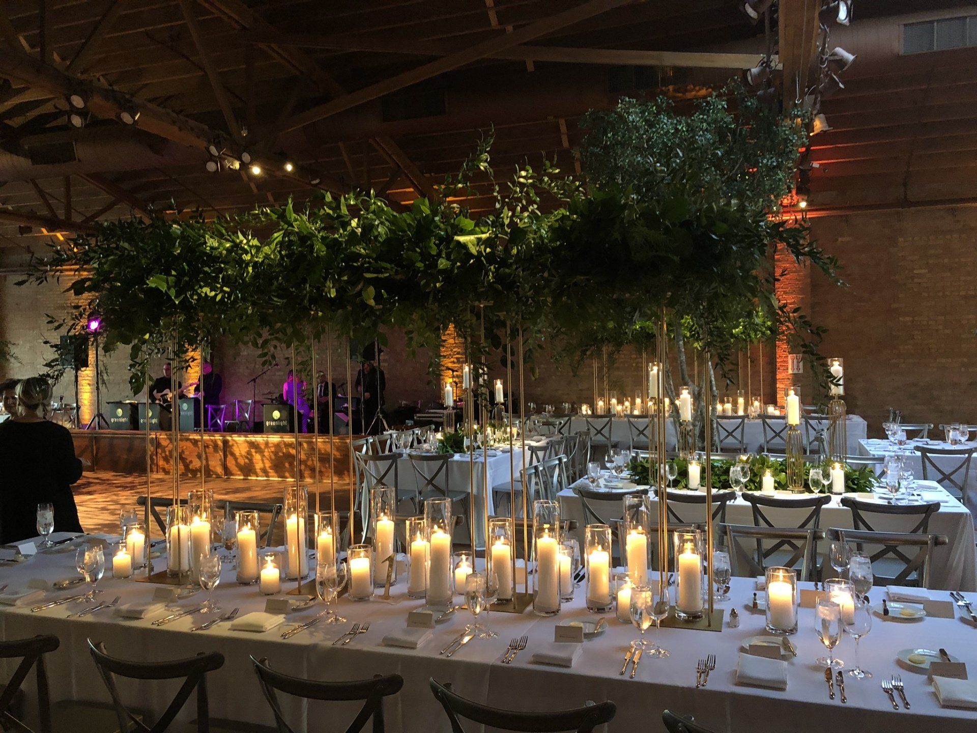 A long table with candles and trees on it
