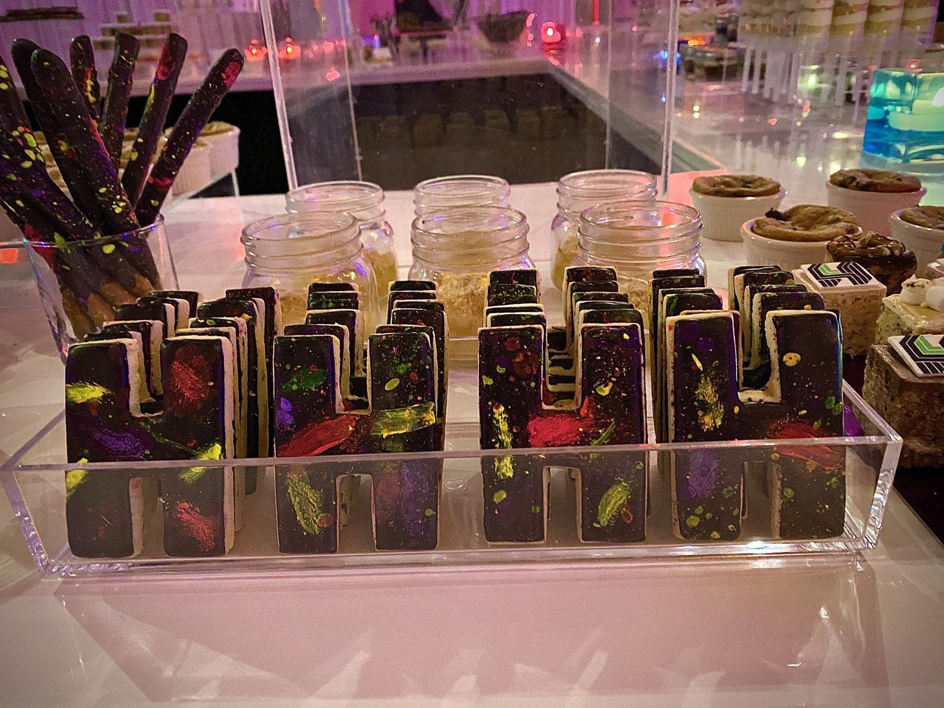 A display of chocolates and jars on a table.