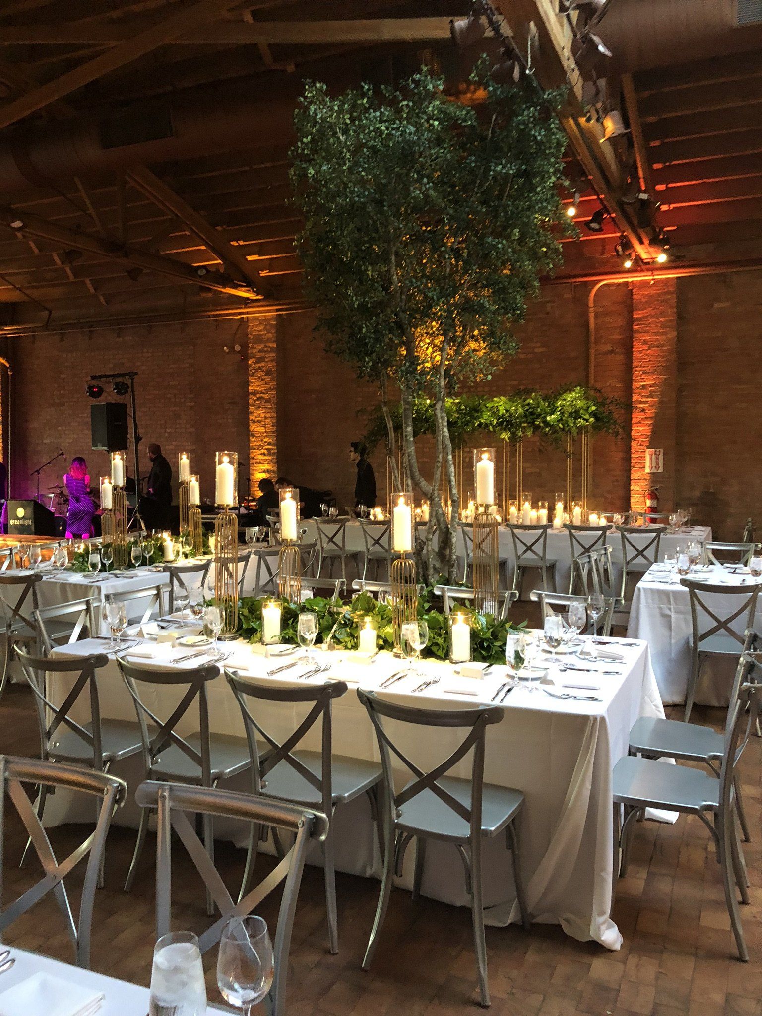 A large room with tables and chairs set up for a wedding reception.