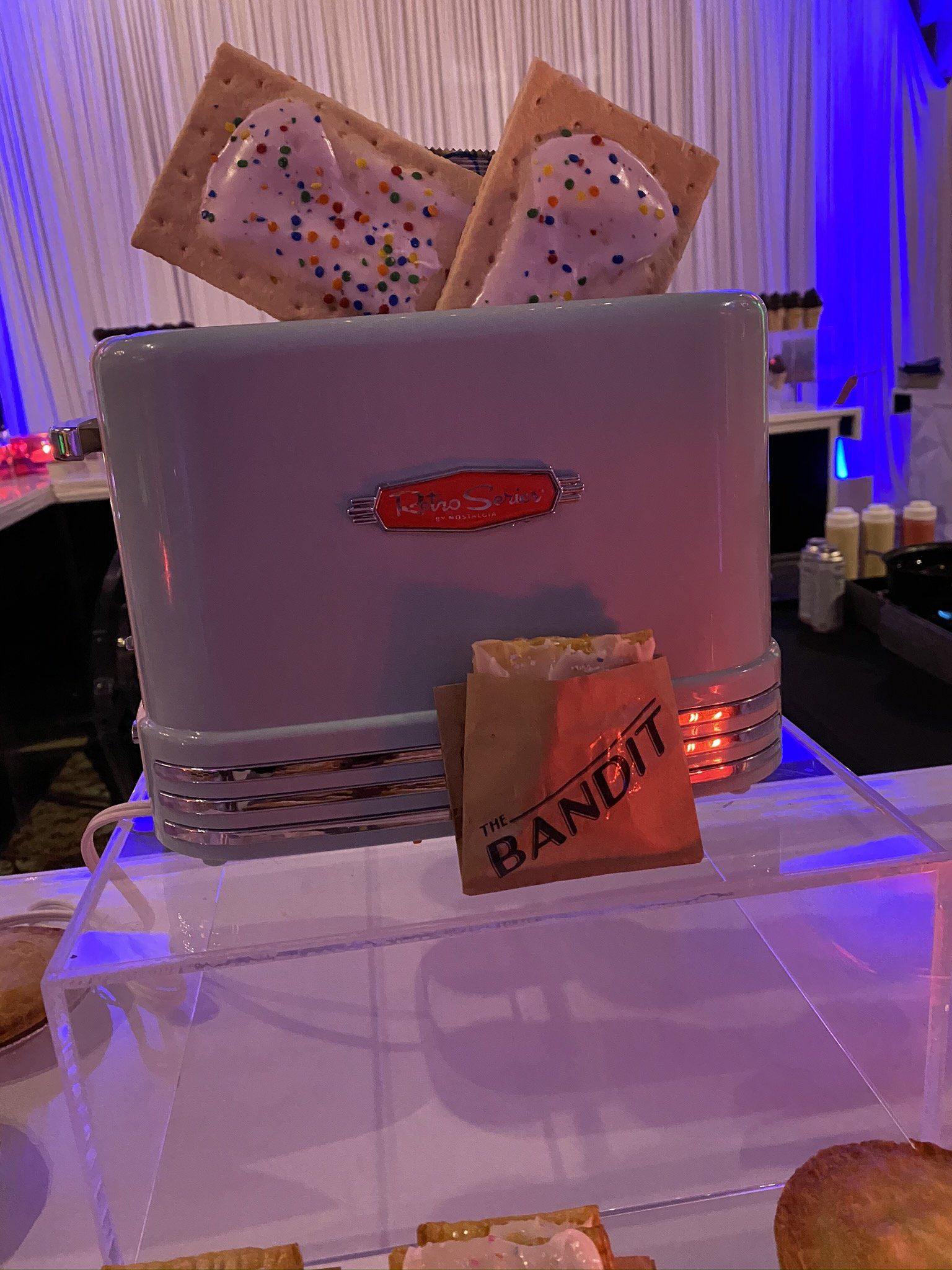 A toaster with two pop tarts in it and a bag of bandit s'mores.