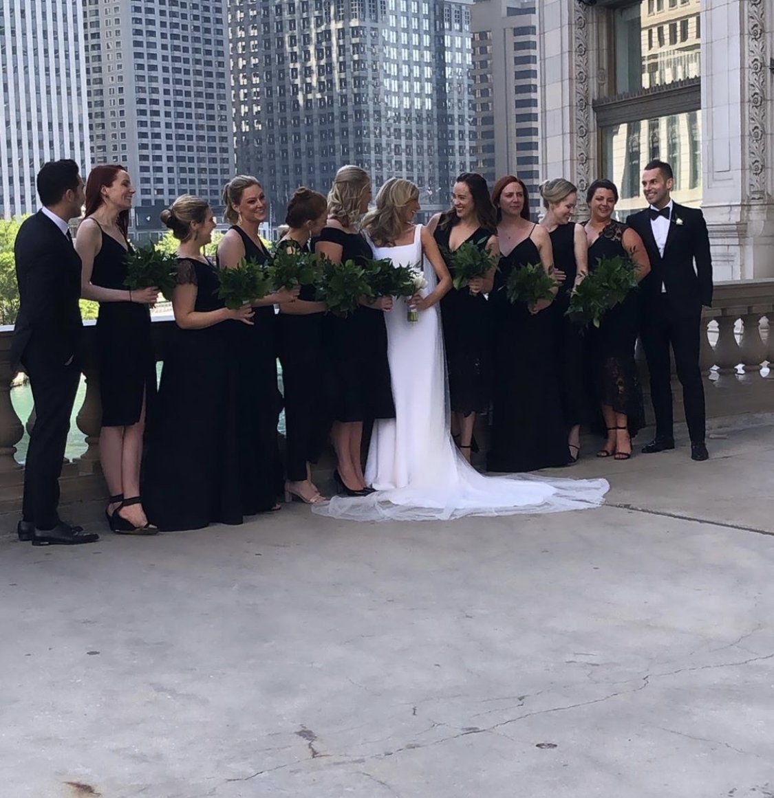 A bride and groom pose with their wedding party