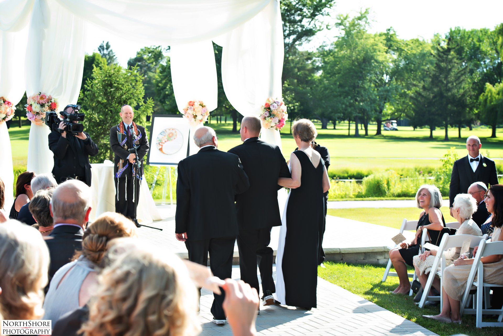 A bride and groom are walking down the aisle at a wedding