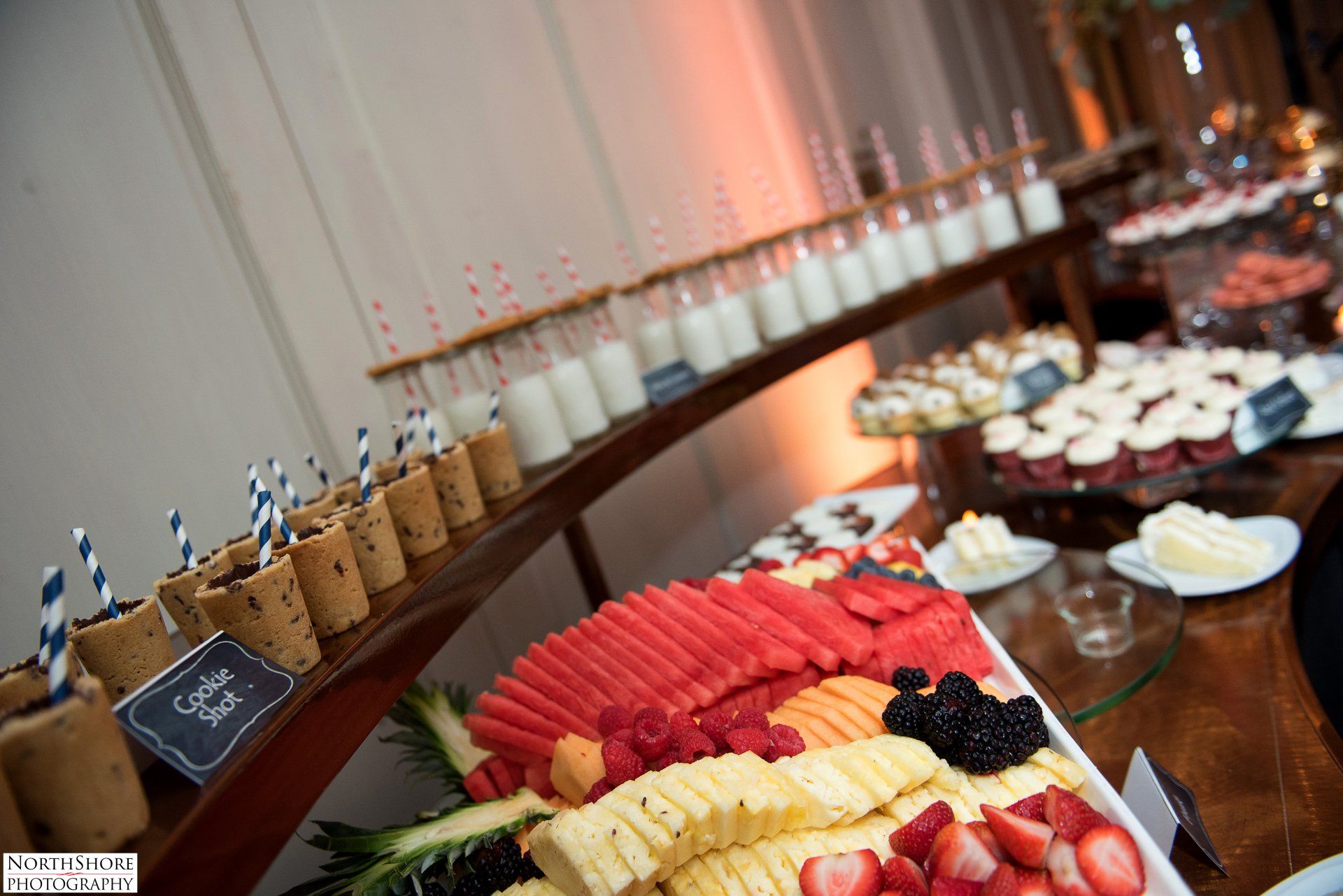 A buffet table with a variety of fruits and desserts on it.