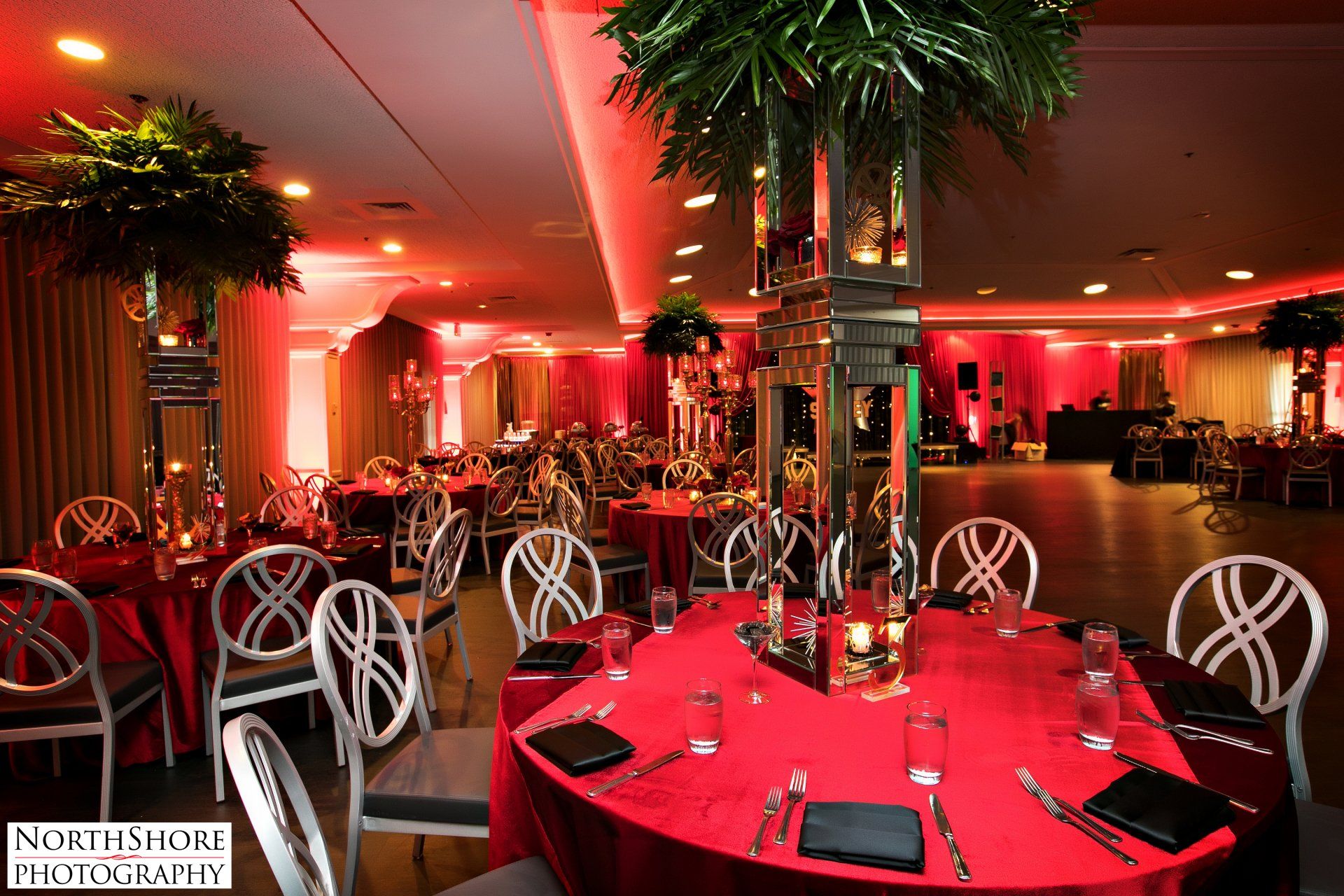 A large room with tables and chairs set up for a party