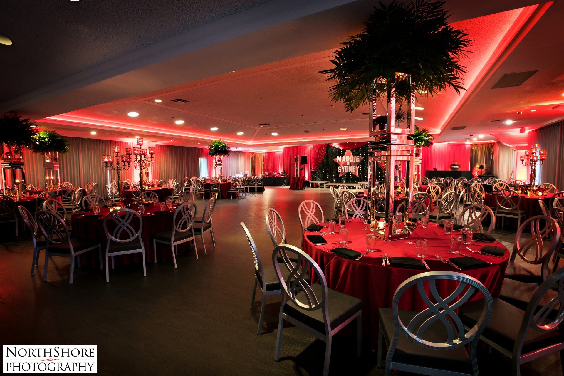 A large room with tables and chairs set up for a party