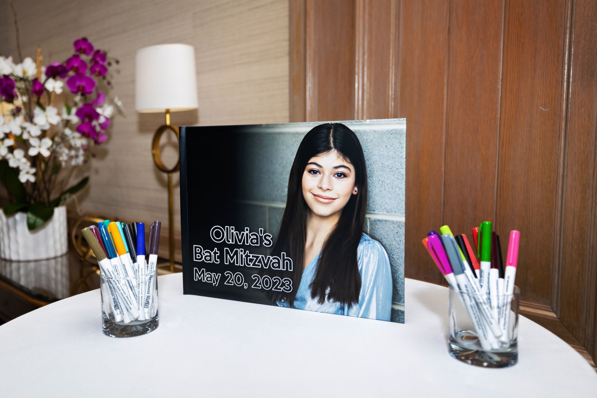 A table with a picture of a girl and markers on it.