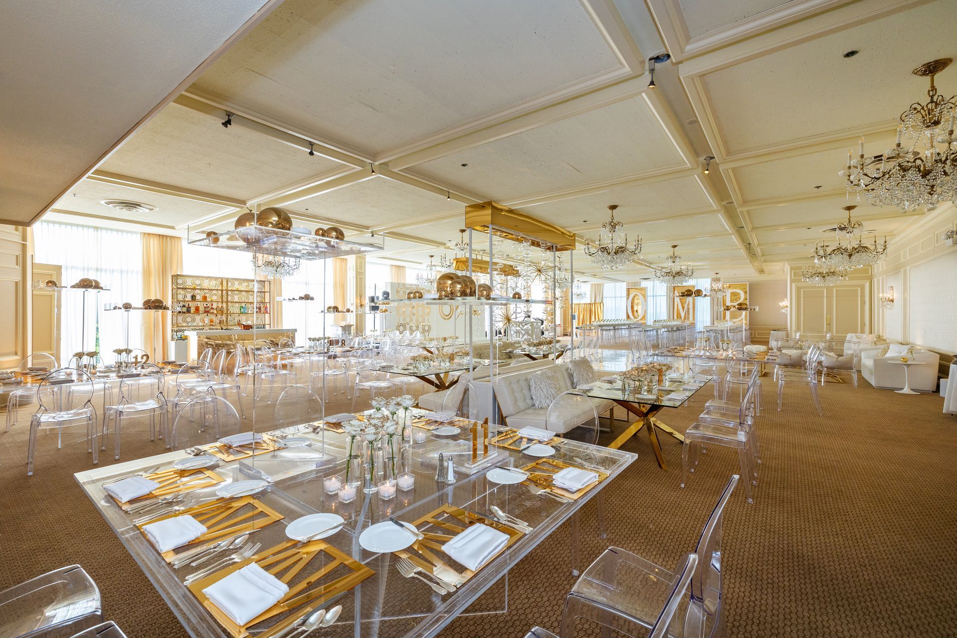 A large room with tables and chairs set up for a wedding reception.