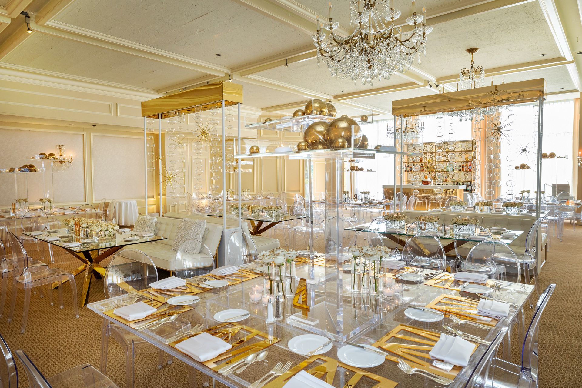 A large room with tables and chairs and a chandelier.