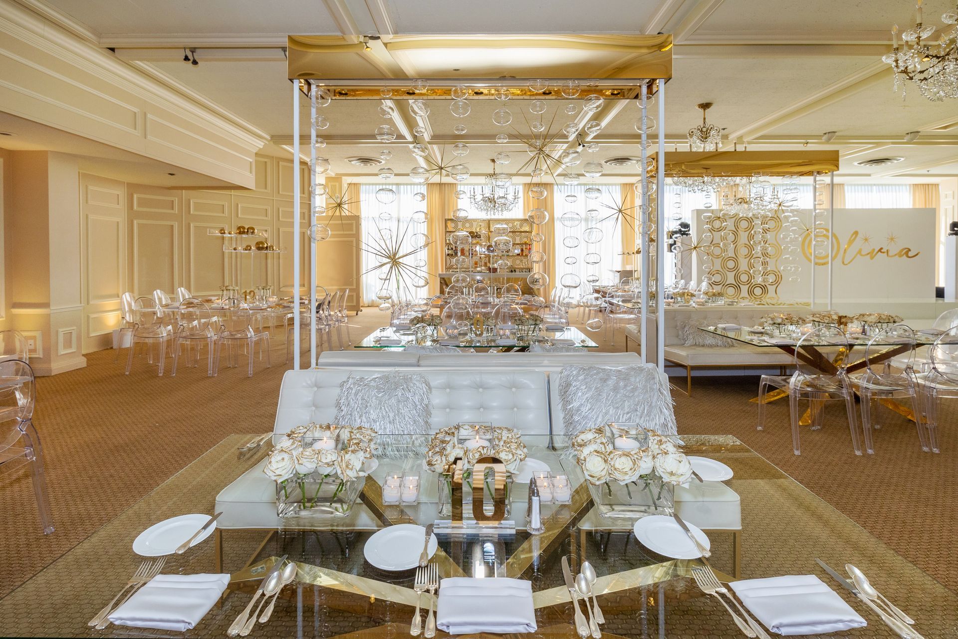 A large room with tables and chairs set up for a wedding reception.