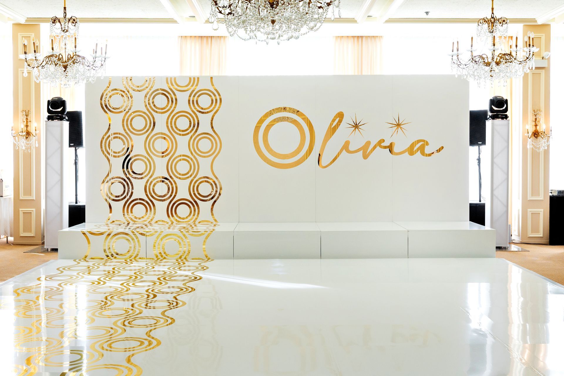 A white wall with the name olivia written on it and a white dance floor.