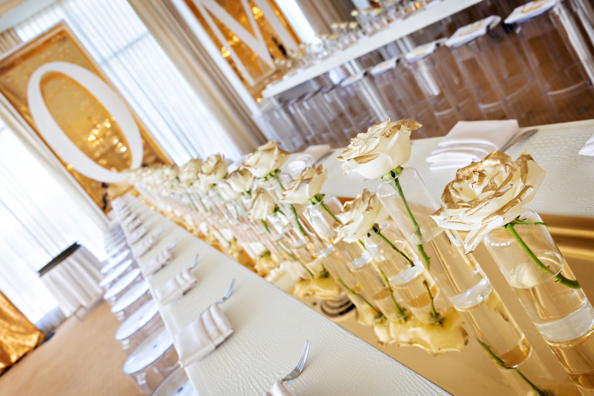 A long table with vases of flowers on it