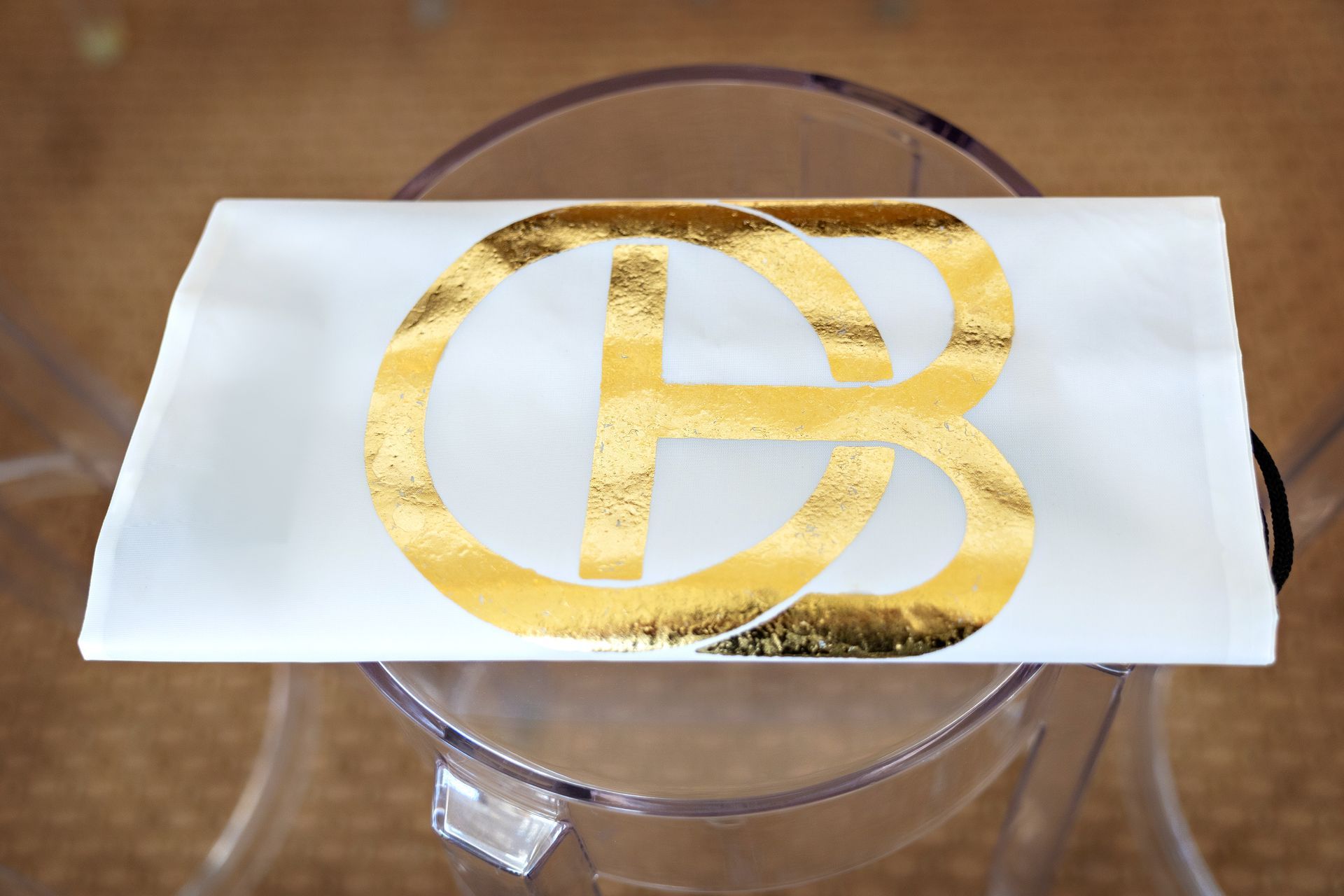 A white piece of paper with a gold letter b on it