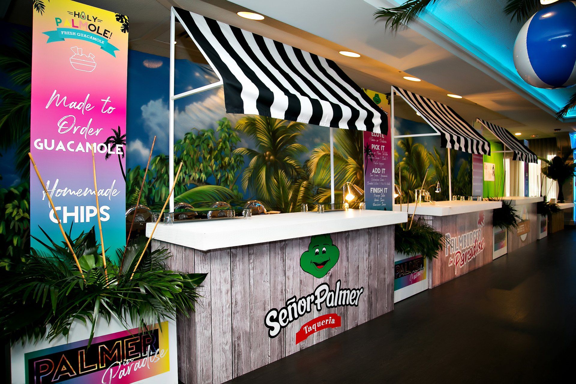 A restaurant with a striped awning that says made to order guacamole