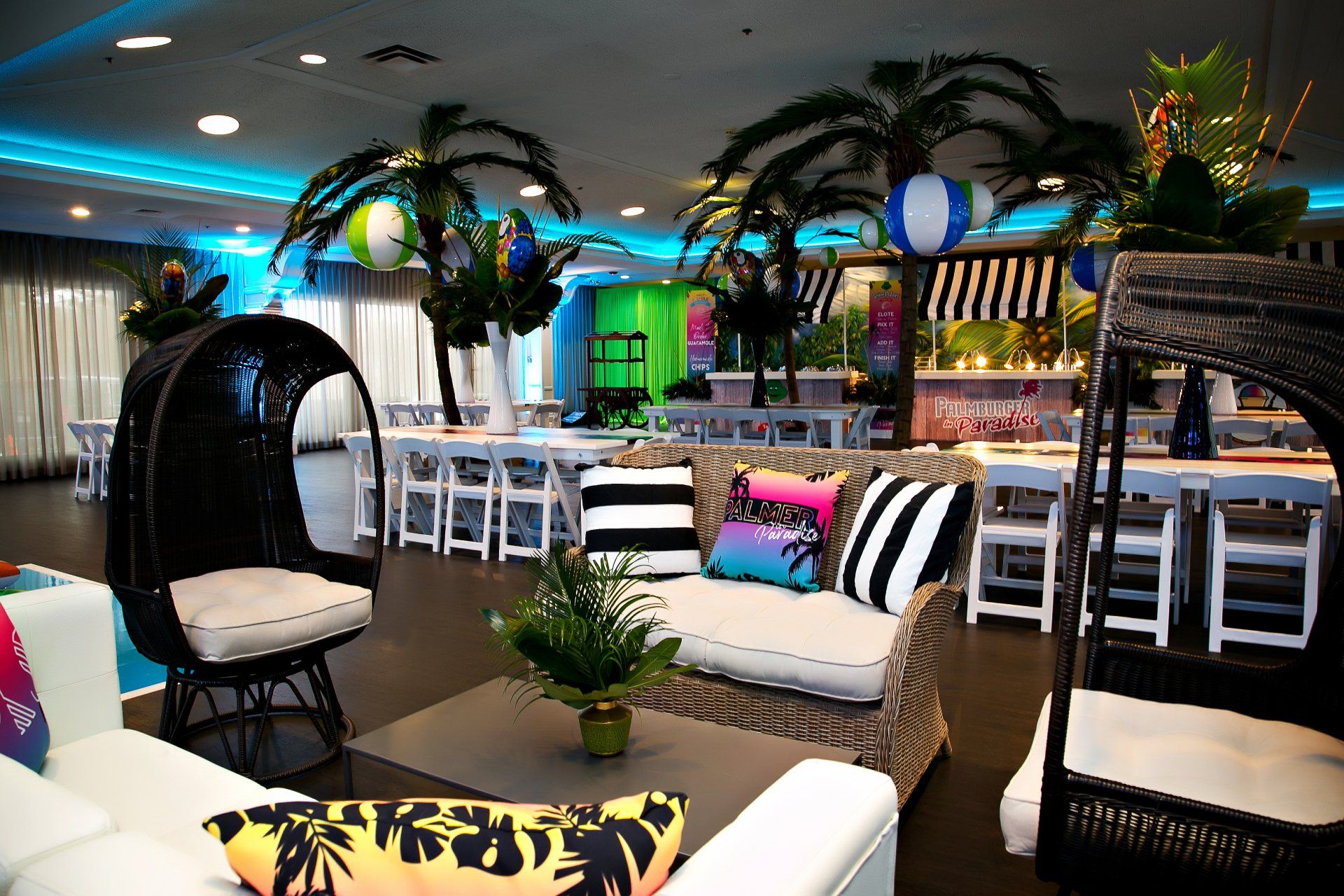 A room with a lot of furniture and palm trees