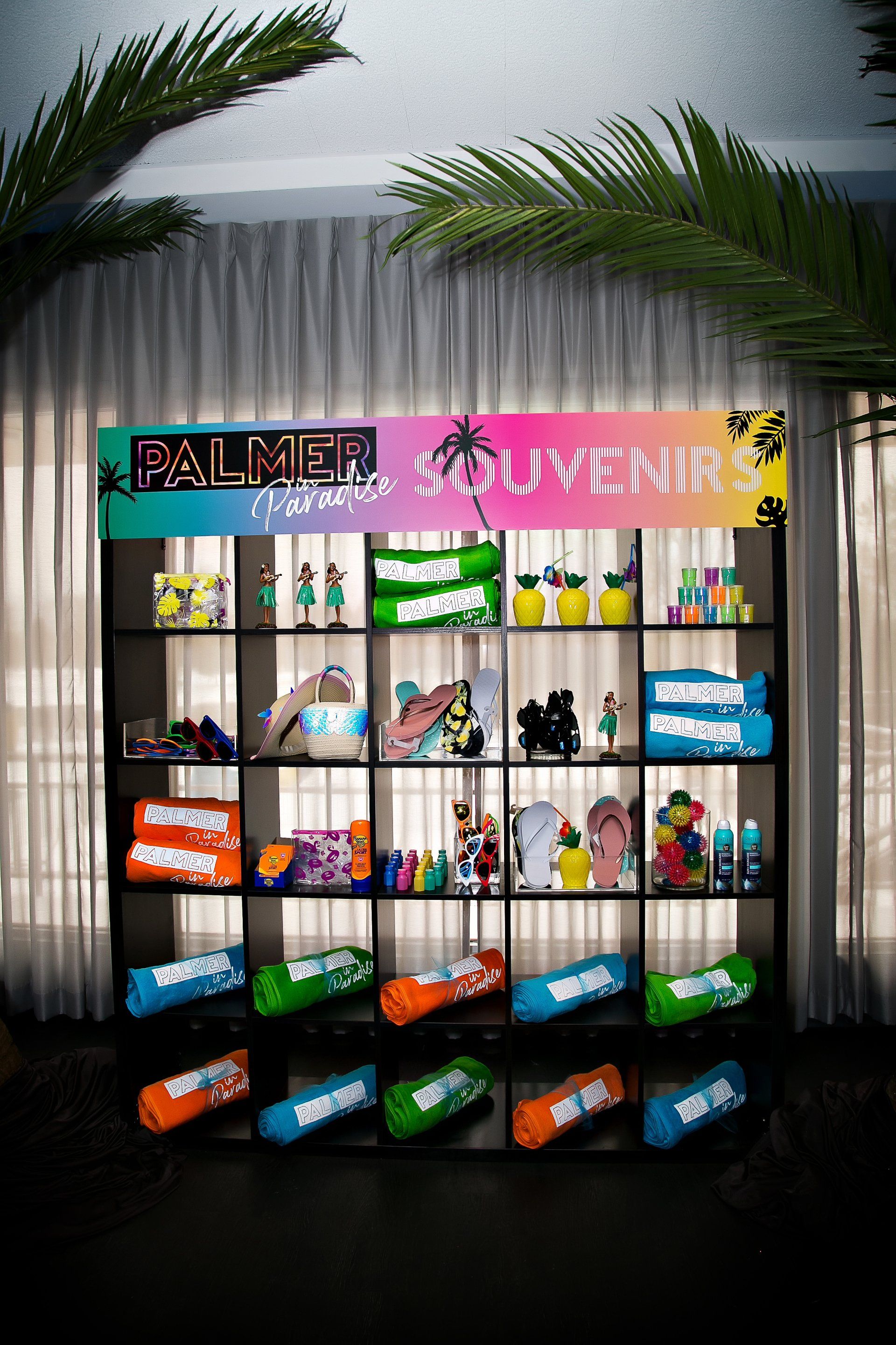 A shelf with a sign that says palmer souvenirs on it