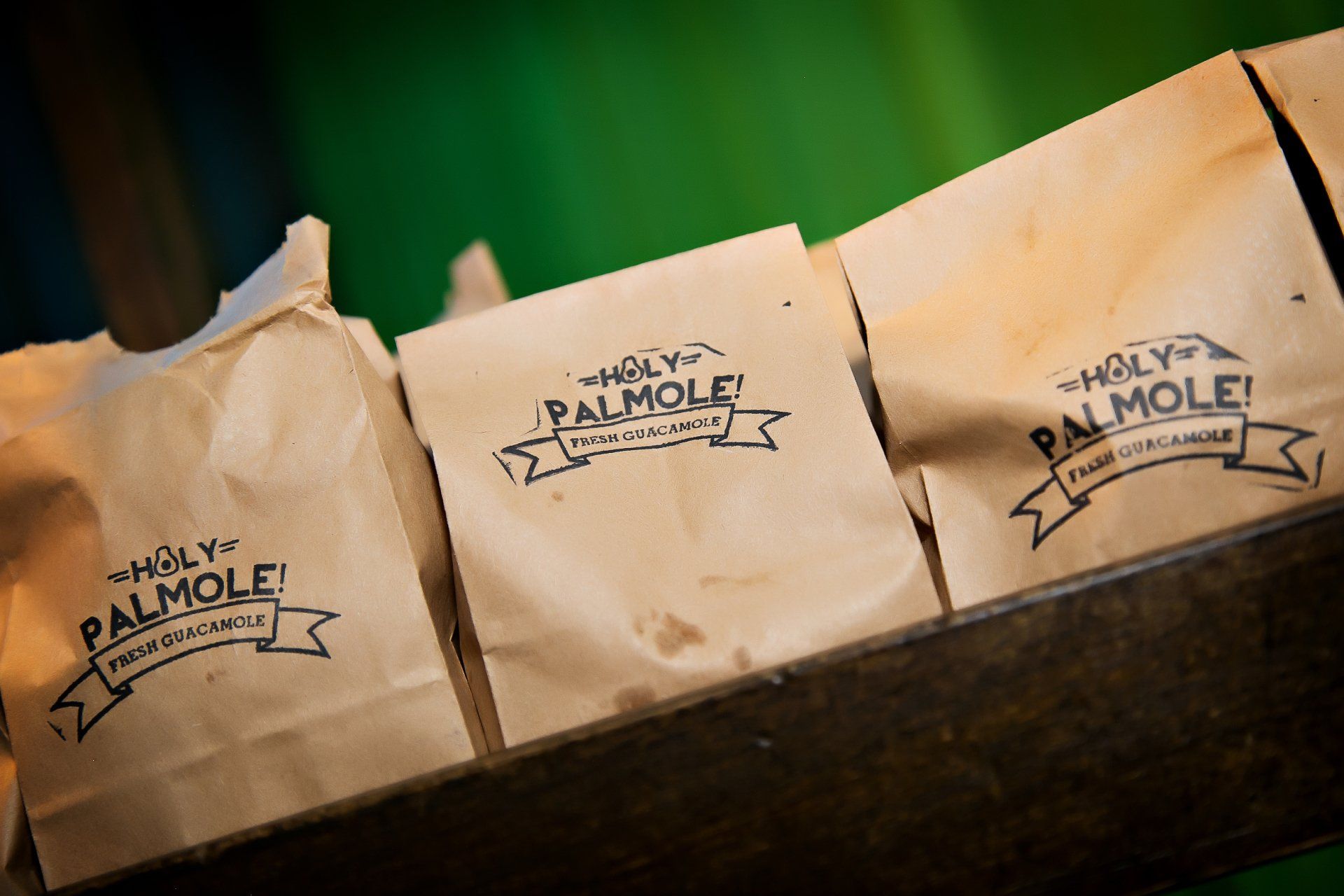 Three bags of holy palmole are sitting on a table.