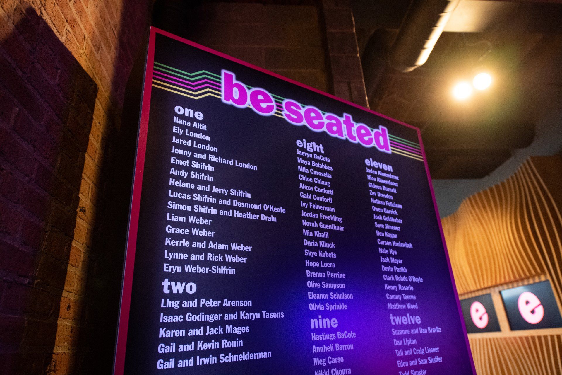 A black board with the words be seated on it