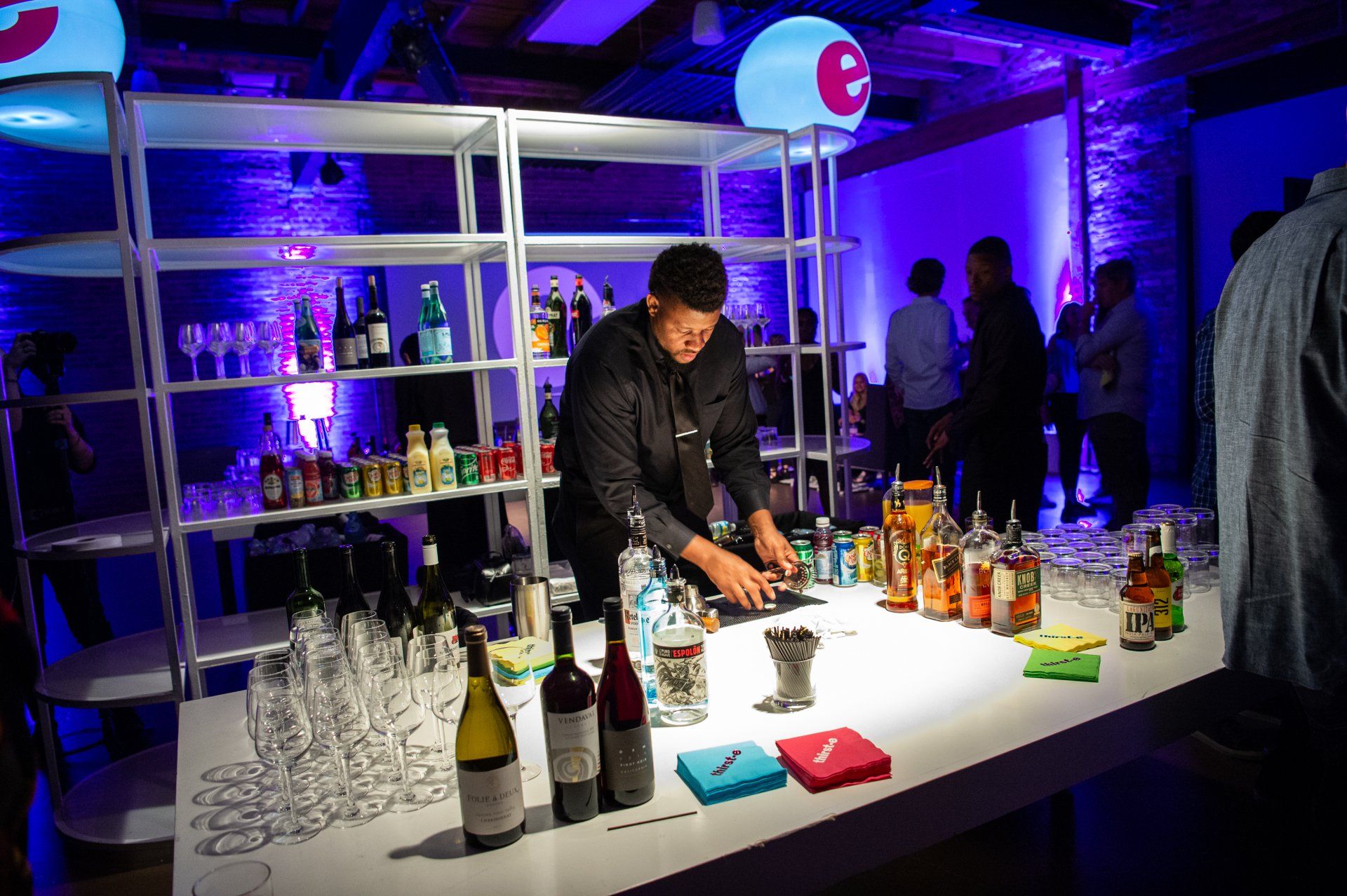 A bartender is preparing a drink at a party.