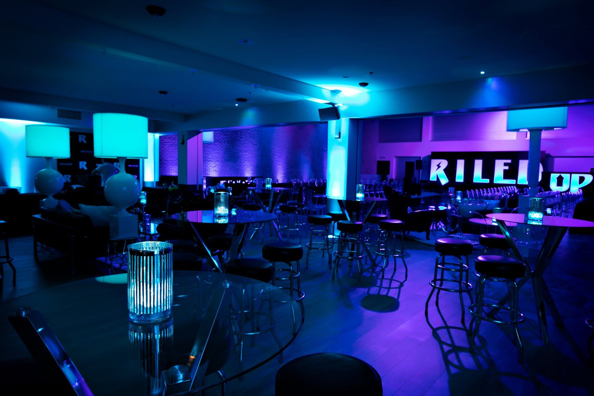 A large room with blue lights and a sign that says rile up