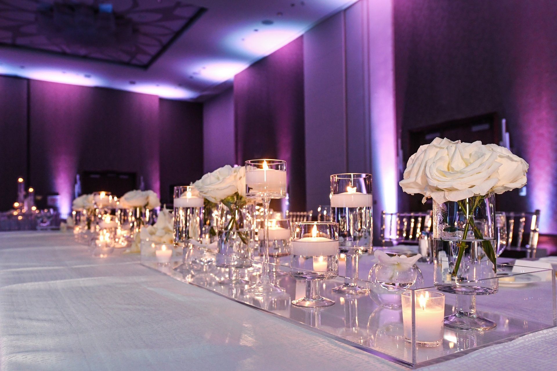 A long table with candles and flowers on it