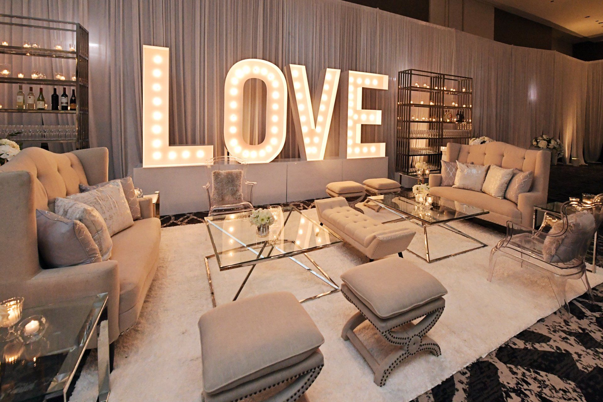 A living room with a large love sign on the wall