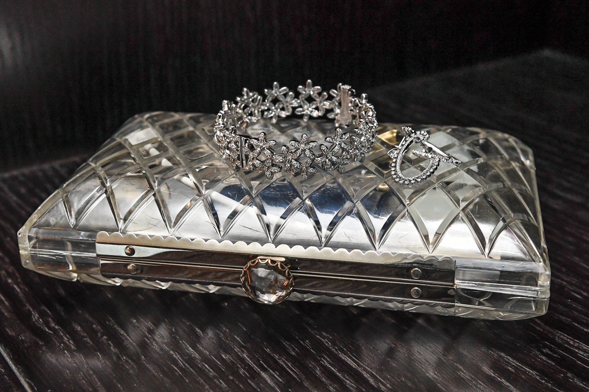 A clear purse with a crown on top of it