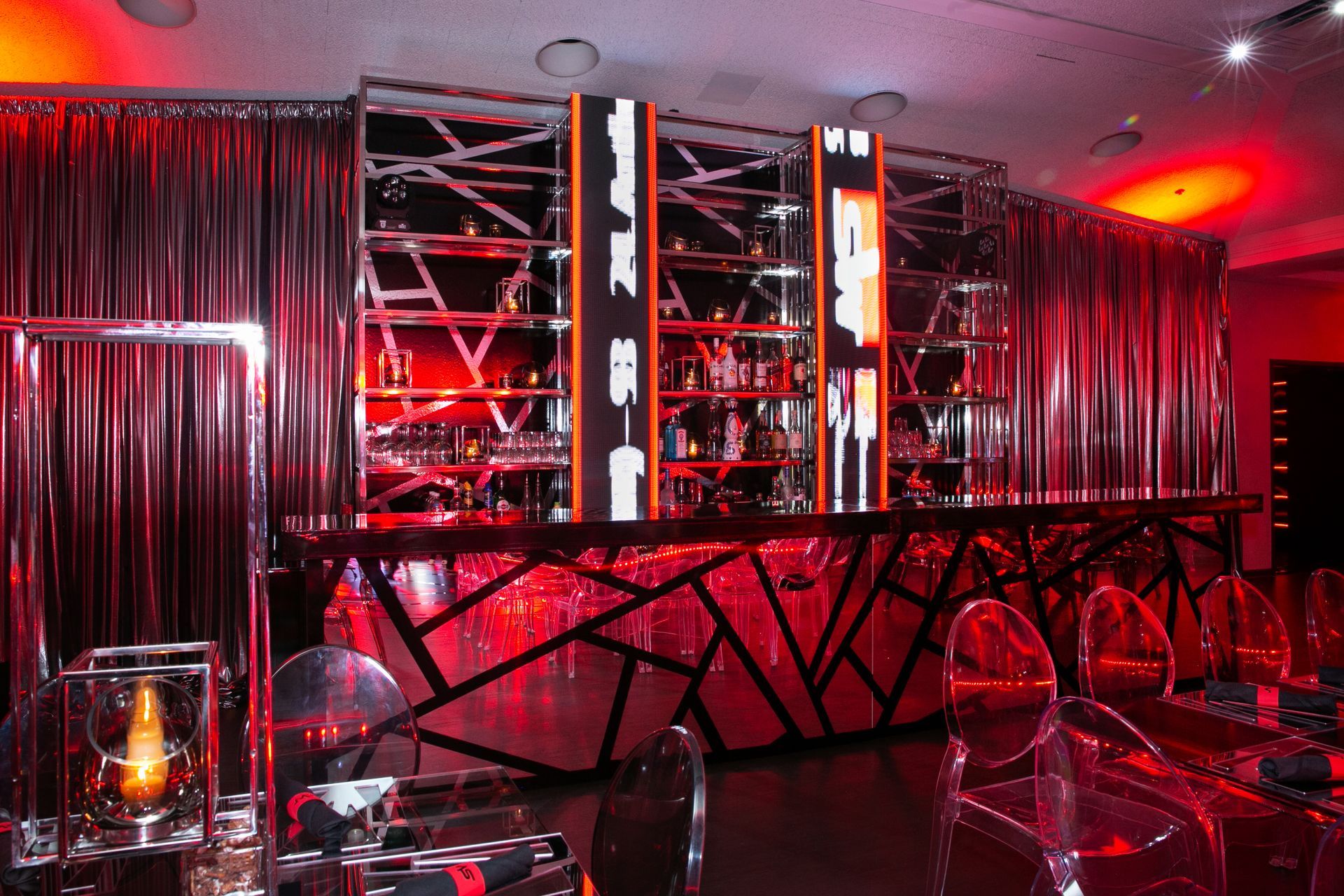A bar in a room with red lights on the walls