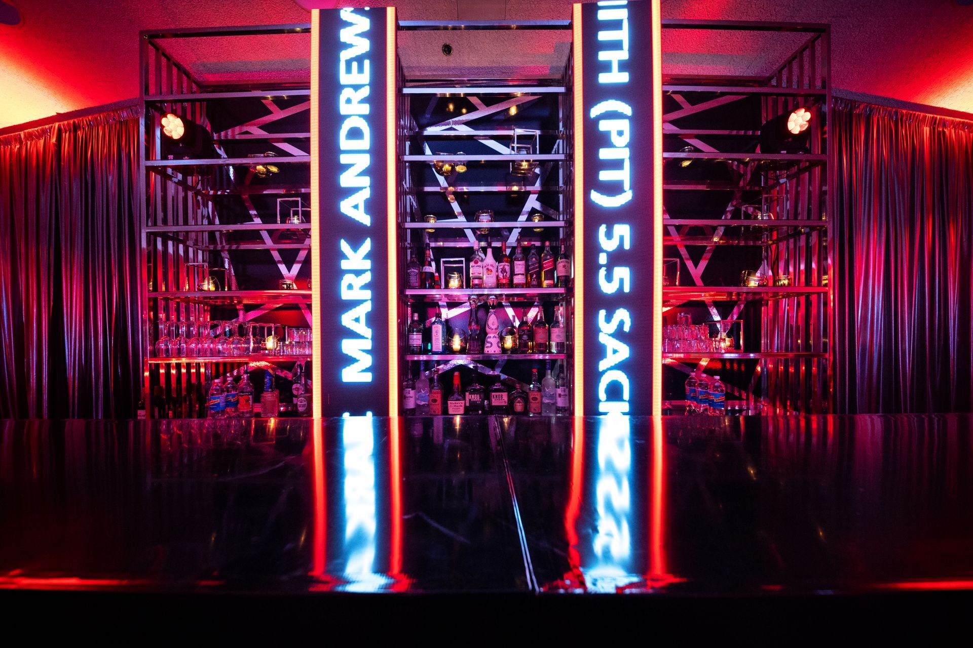 A neon sign that says mark andrew on it