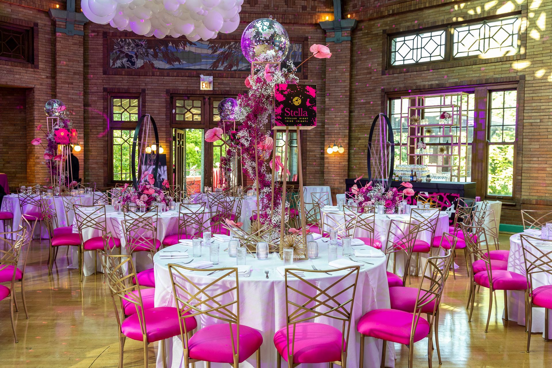 A large room filled with tables and chairs set up for a party.