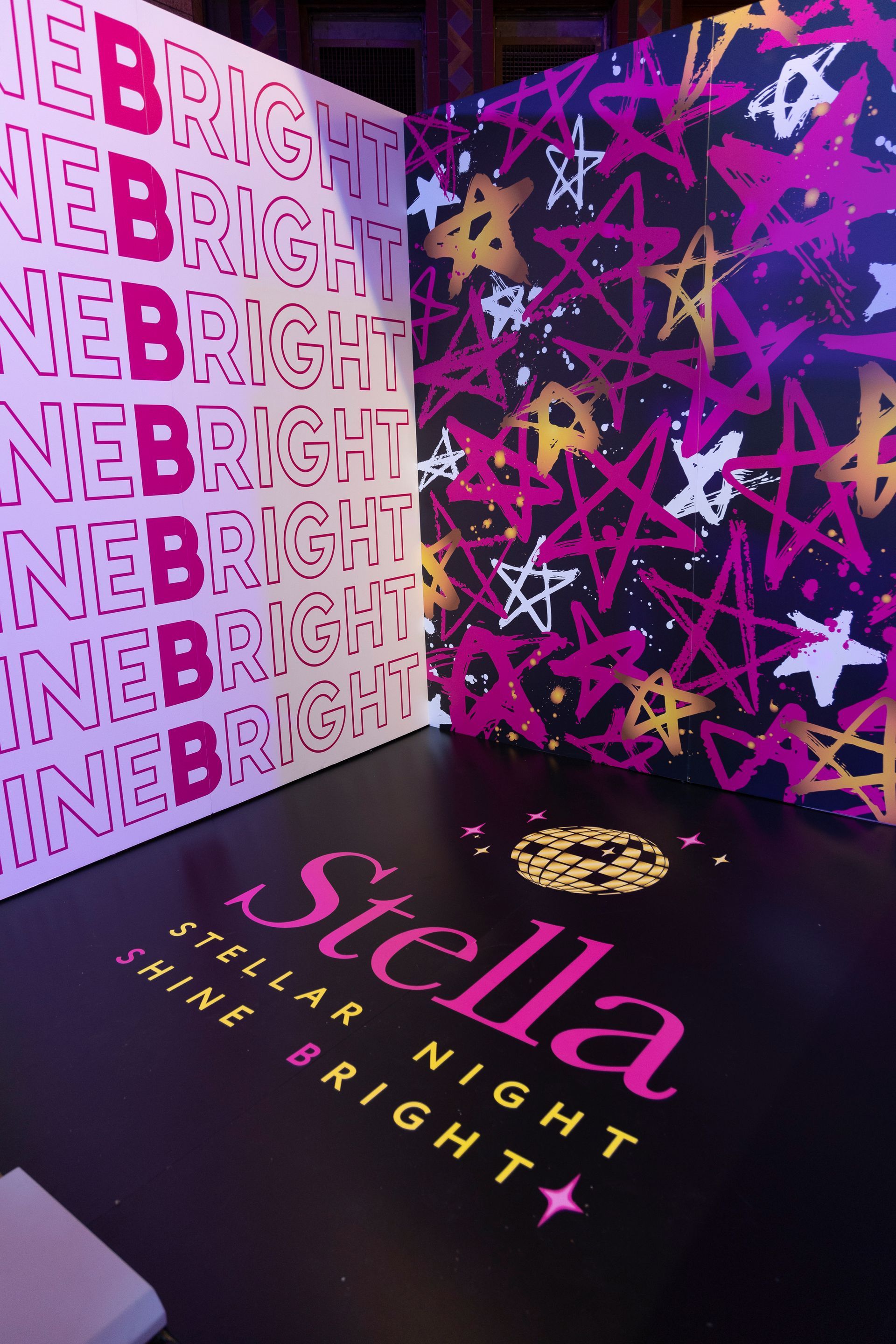 A room with a stella shine bright sign on the floor