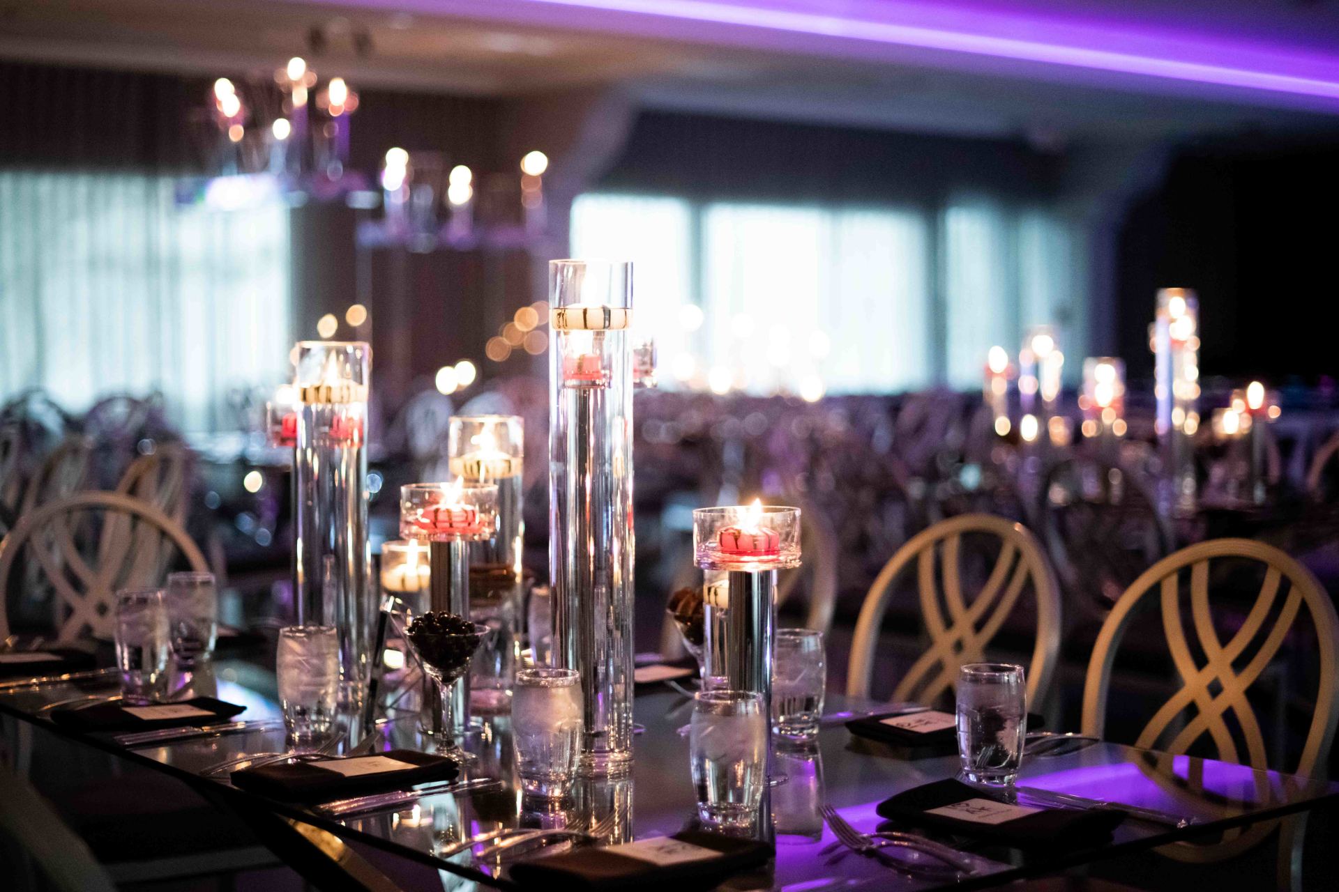 A long table with a lot of candles on it.