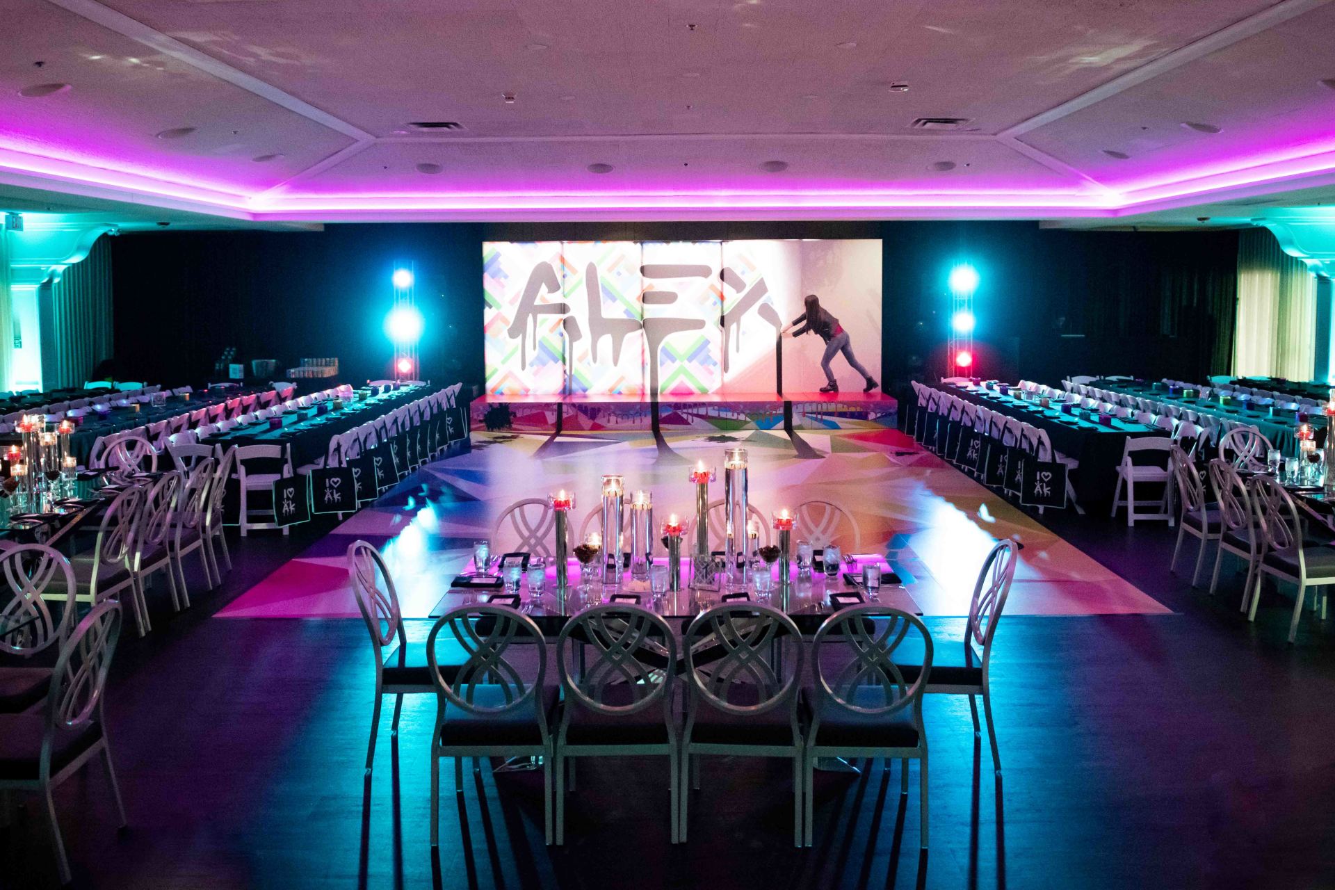 A large room with tables and chairs and a dance floor