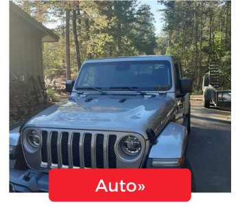 A silver Jeep parked outdoors on a sunny day, overlaid with a red button labeled 
