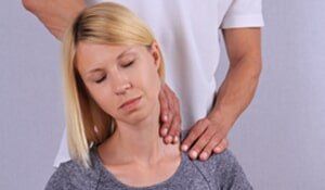 A woman getting back pain chiropractor services in the Millersburg, OH, area
