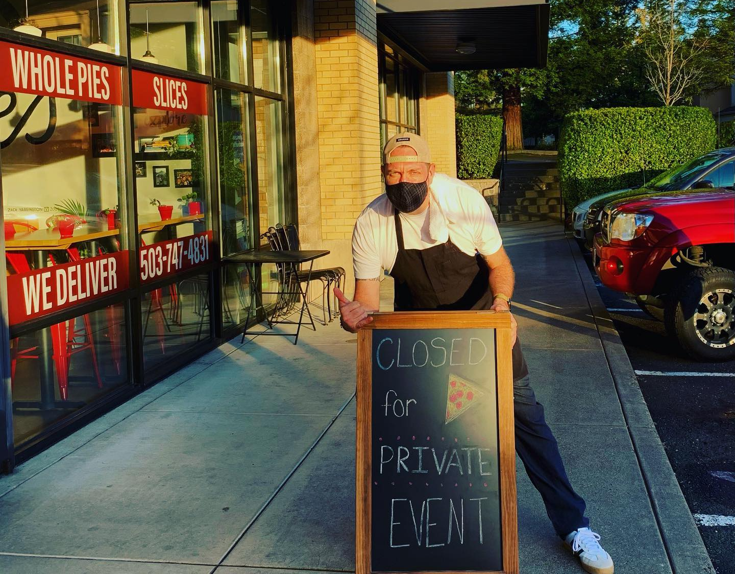 Josh outside with sign for a private event.