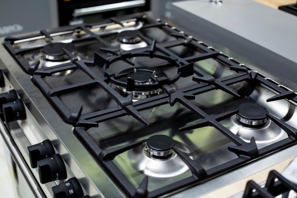 A Stainless Steel Gas Stove With a Lot of Burners — Commercial Kitchens Direct in Unanderra, NSW