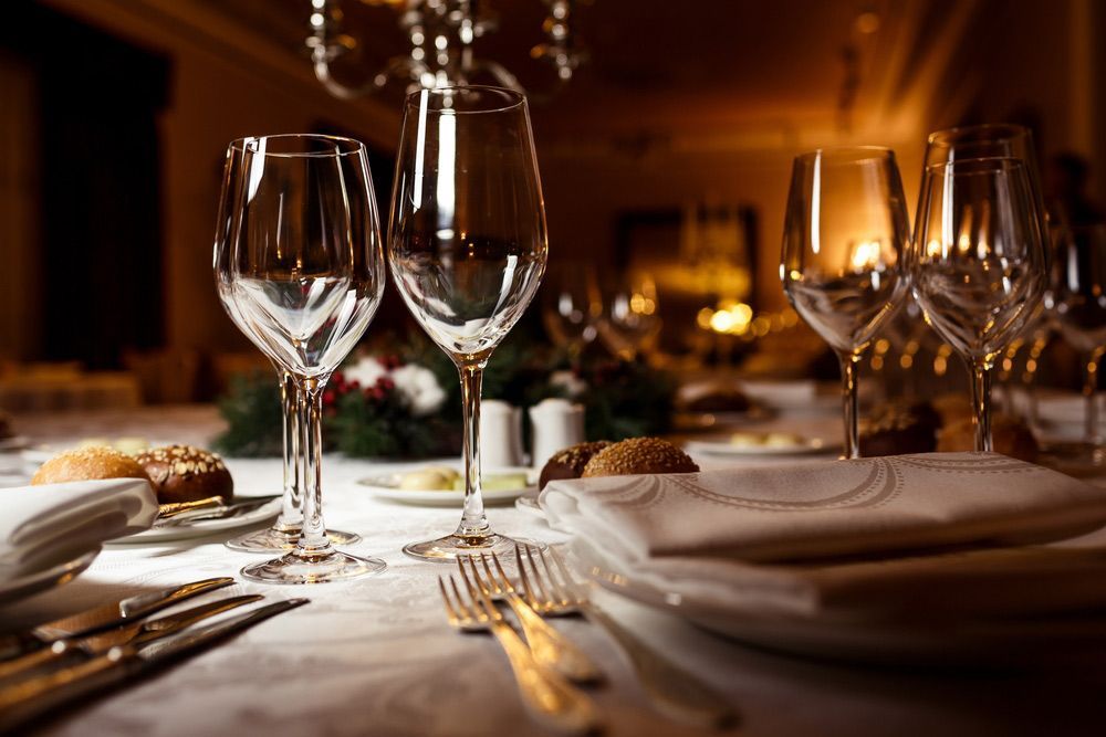 A Table Set for a Dinner Party With Wine Glasses and Silverware — Commercial Kitchens Direct in Shoalhaven, NSW