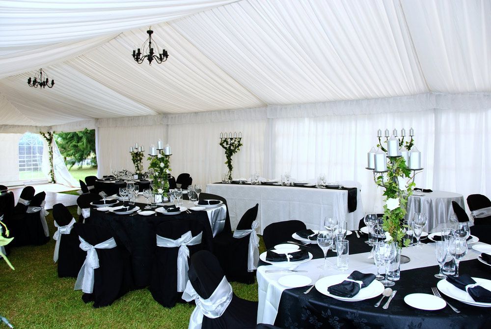 A White Tent With Black and White Tables and Chairs — Commercial Kitchens Direct in Unanderra, NSW