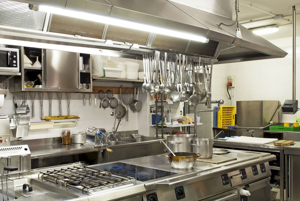 Two Pots Are Sitting on Top of a Stove in a Kitchen — Commercial Kitchens Direct in Southern Highlands, NSW