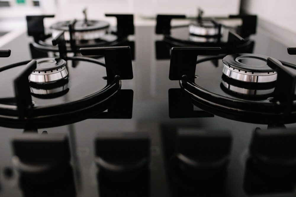 A Person is Pressing a Button on a Dishwasher — Commercial Kitchens Direct in Shellharbour, NSW