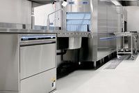 A Kitchen With a Dishwasher Open and Filled With Dishes and Glasses — Commercial Kitchens Direct in Unanderra, NSW