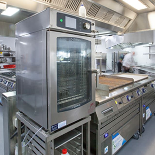 A Large Stainless Steel Oven is in a Kitchen — Commercial Kitchens Direct in Shoalhaven, NSW