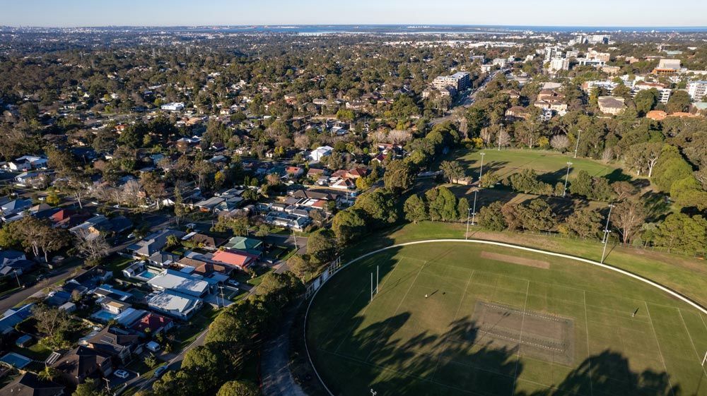 An Aerial View of a Soccer Field in a Residential Area Surrounded by Trees — Commercial Kitchens Direct in Sutherland Shire, NSW