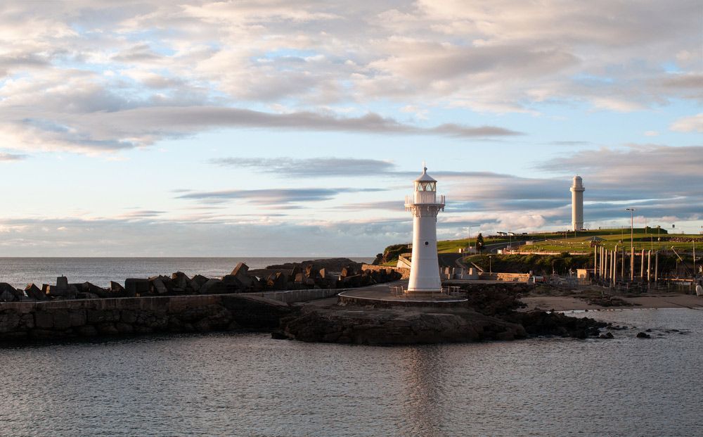 A Lighthouse is Sitting on Top of a Small Island in the Middle of the Ocean — Commercial Kitchens Direct in Wollongong, NSW
