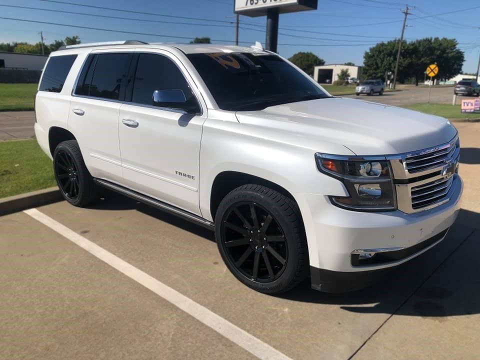 A white suv is parked in a parking lot.